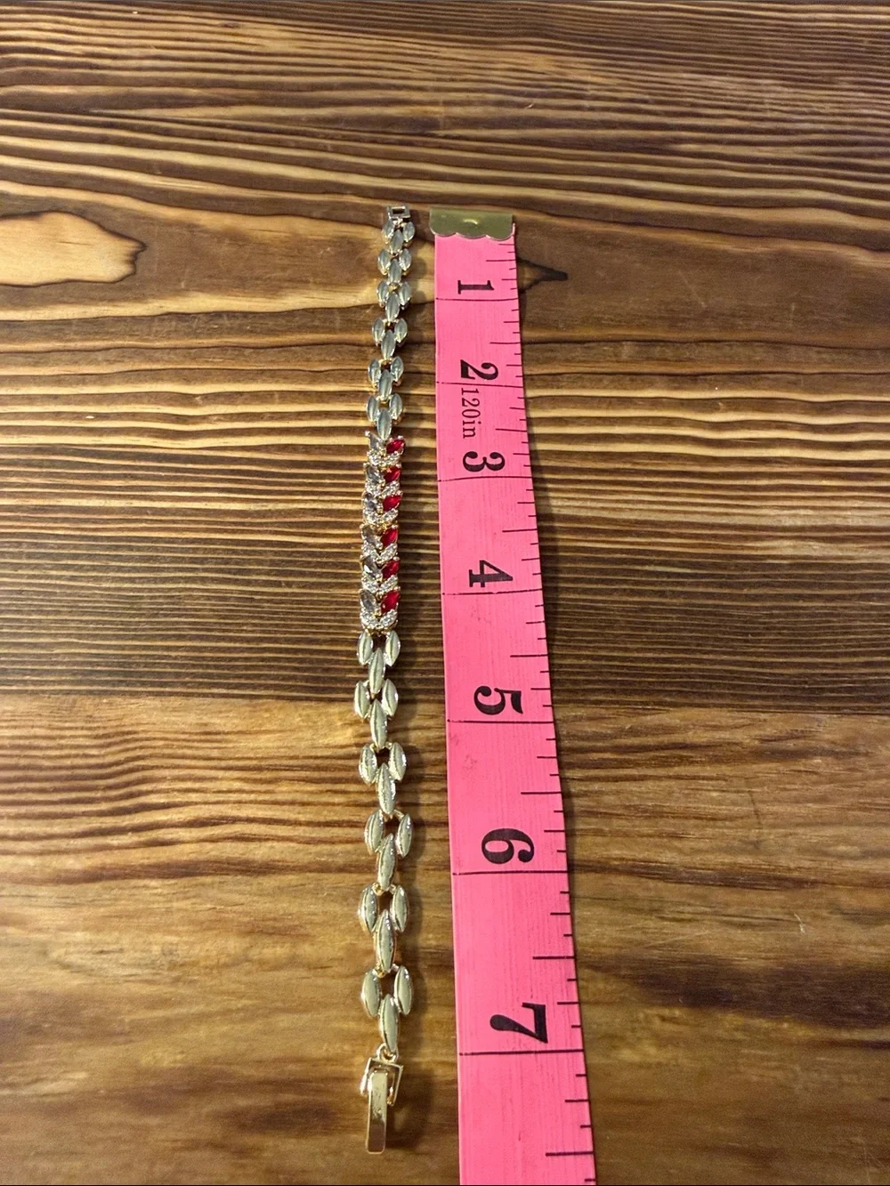 Gold-Tone Bracelet with Red Gem Leaf Accents